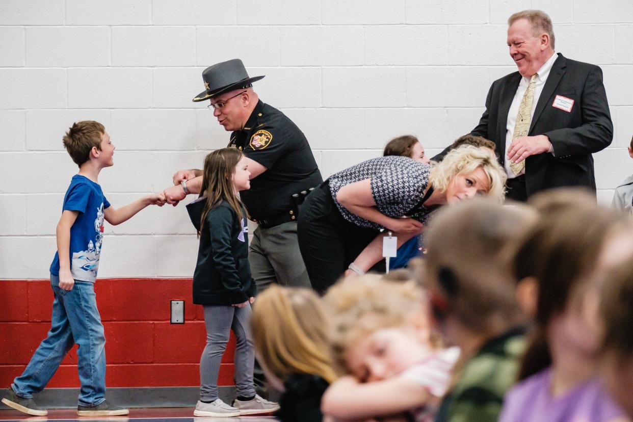 Tuscarwas County Sheriff Orvis Campbell greets children before the Milken Educator Award ceremony at Midvale Elementary, Thursday, Apr. 14.