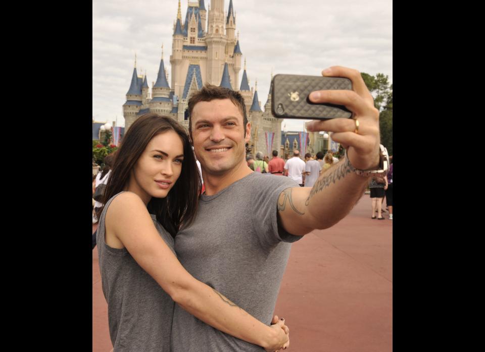 Brian Austin Green (right) and his wife, actress/model Megan Fox (left), take a souvenir photo in the Magic Kingdom November 26, 2010 in Lake Buena Vista, Florida.     (Photo by Gene Duncan/Disney via Getty Images)