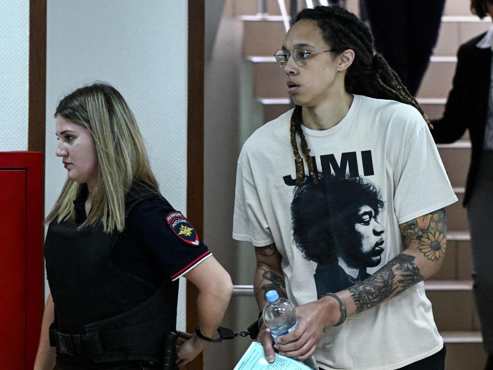 Basketball star Brittney Griner (right) arrvies at court near Moscow in handcuffs (AFP via Getty Images)