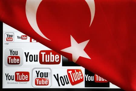 YouTube logos displayed on a laptop screen partially covered with Turkey's national flag in this photo illustration taken in Ankara March 27, 2014. REUTERS/Umit Bektas