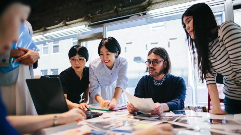 Group of people are working together in a modern working space in Tokyo.