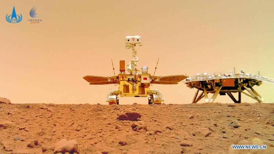 China's rover Zhurong (center) explores the Martian surface in a new photo released June 11, 2021.