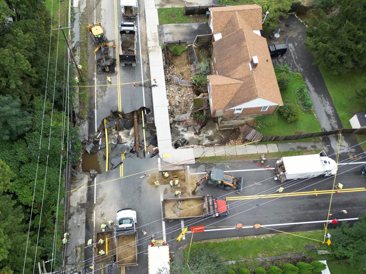 Crews work on a section of Pleasant Street in Leominster, Mass., which was washed out Tuesday (Copyright 2023 The Associated Press. All rights reserved)