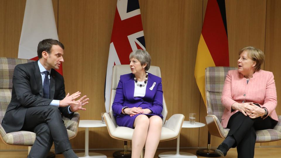 Theresa May in discussion with Emmanuel Macron and Angela Merkel last night (Getty)