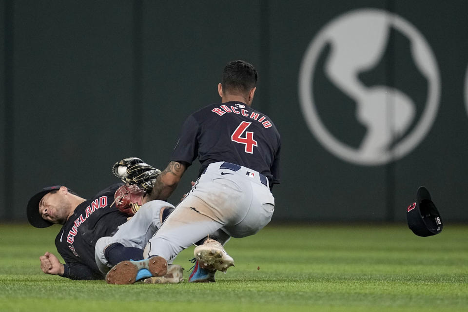 Cleveland Guardians' Tyler Freeman, left, and Brayan Rocchio (4) fall after colliding making a play on a fly out by Texas Rangers' Adolis Garcia in the fifth inning of a baseball game, Tuesday, May 14, 2024, in Arlington, Texas. Freeman caught the ball on the play. (AP Photo/Tony Gutierrez)