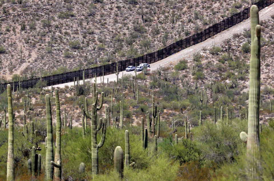 FILE - U.S. Customs and Patrol Patrol agents sit along a section of the international border wall that runs through Organ Pipe Cactus National Monument, Thursday, Aug. 22, 2019 in Lukeville, Ariz. U.S. Border Patrol agents answering reports of gunfire shot and killed a man on a tribal reservation in southern Arizona after he abruptly threw something and raised his arm, the agency said Monday, May 22, 2023. (Matt York / AP file)