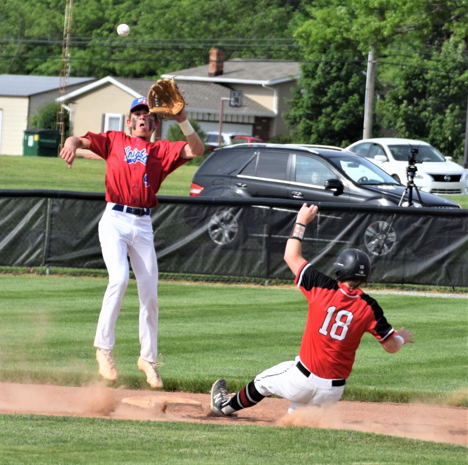 West Holmes sophomore shortstop Hunter Aurand leaps to haul in a throw trying to catch Gaven Blake stealing second in the first inning.