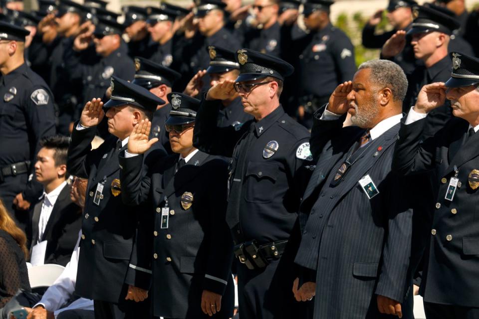 Family, friends, city officials and fellow officers salute fallen Los Angeles Police Officer Houston Tipping as they gather at Forest Lawn Hollywood Hills - Hall of Liberty Mosaic Deck for his funeral Wednesday, June 22, 2022, in Los Angeles (AP)