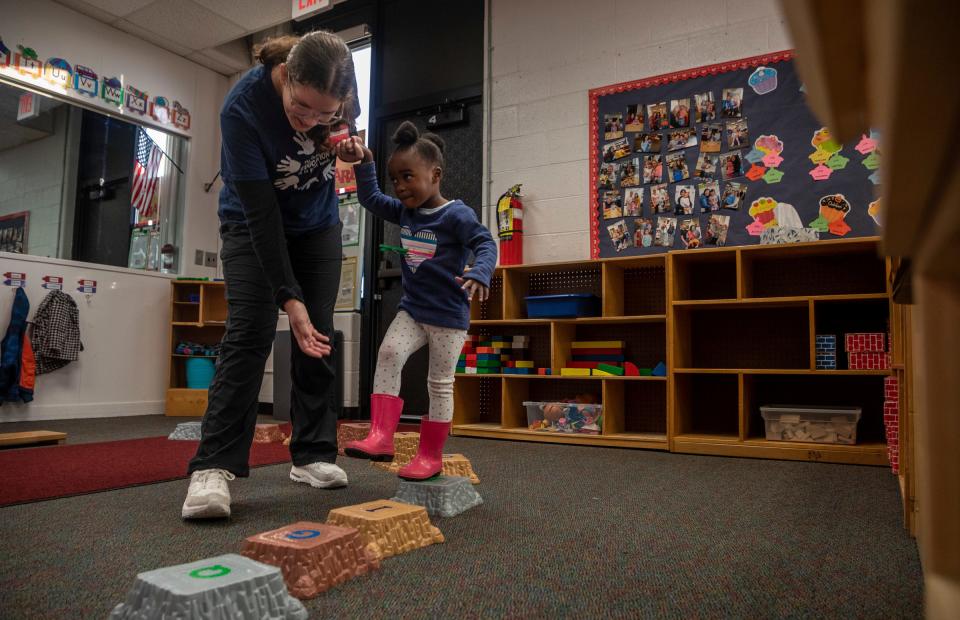 Emma Heenan, a junior at Salem High School, holds the hand of a preschool student during a Kiddie Campus class in Canton on Oct. 26, 2023. The Kiddie Campus class is one of the specialized classes offered at the Plymouth-Canton Educational Park that is geared toward students who might find a career related to early childhood education or teaching.