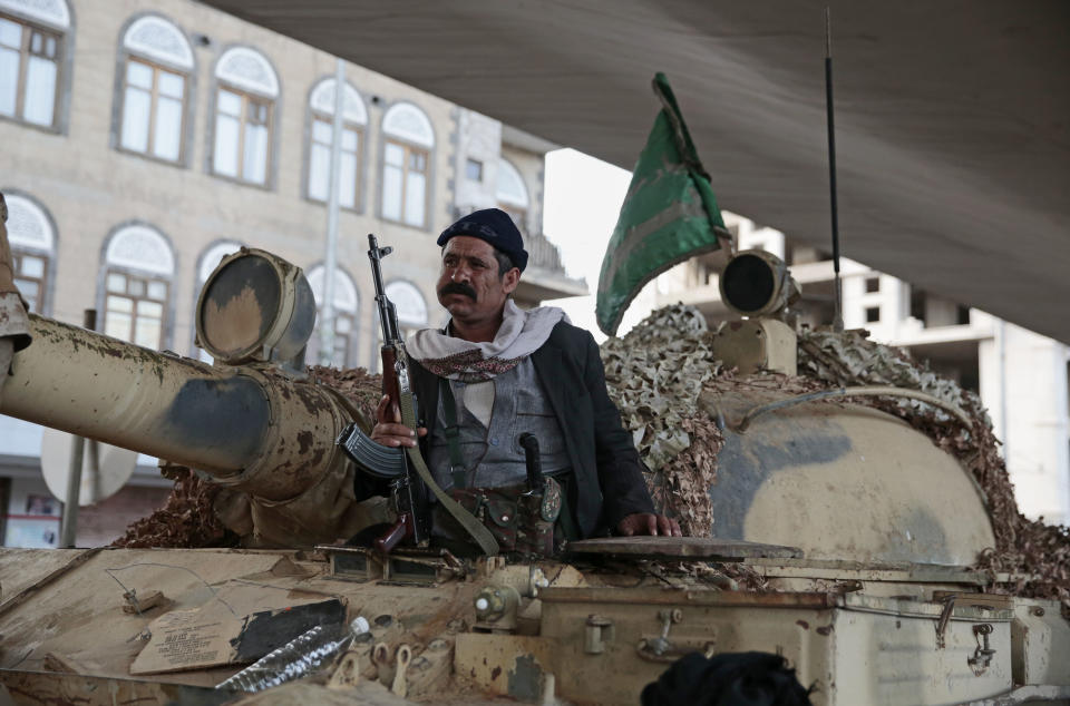 FILE - In this Dec. 4, 2017 file photo, a Houthi Shiite fighter rides on a tank while guarding a street leading to the residence of former Yemeni President Ali Abdullah Saleh, in Sanaa, Yemen. Saleh was killed by Shiite rebels, Monday as their forces battled for control of the capital, Sanaa, officials said. (AP Photo/Hani Mohammed, File)