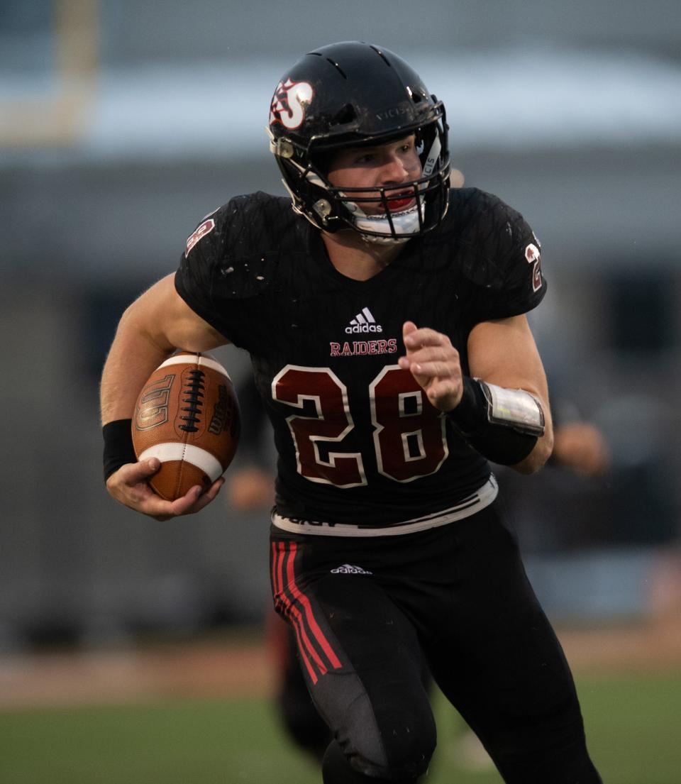 Southridge’s Reid Schroeder (28) runs the ball as the Southridge Raiders play the Lawrenceburg Tigers for the Class 3A Regional at Southridge High School in Huntingburg, Ind.,  Saturday evening, Nov. 12, 2022.