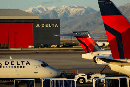 FILE PHOTO: A Delta Air Lines flight is pushed put of its gate at the airport in Salt Lake City, Utah, U.S., January 12, 2018. REUTERS/Mike Blake/File Photo