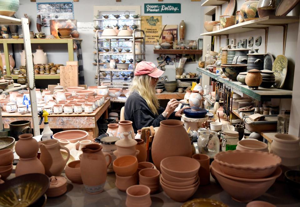 Terry Plasket, resident potter at Wheaton Arts and Cultural Center in Millville N.J., paints pottery in his studio on Tuesday, Nov. 16, 2021.