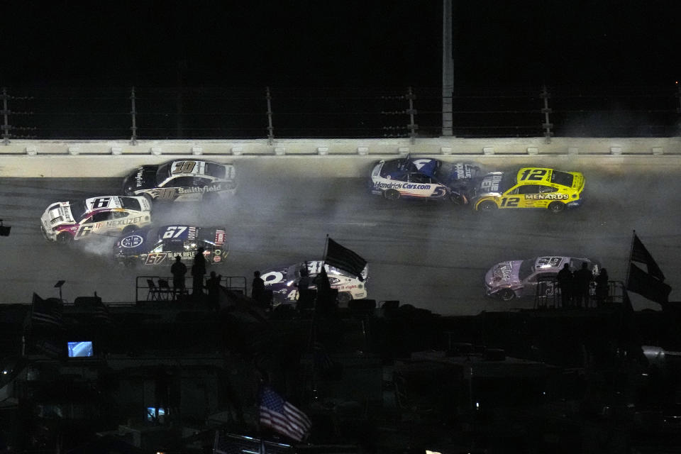 Aric Almirola (10), Brad Keselowski (6), Travis Pastrana (67), Kyle Larson (5), Ryan Blaney (12), and Daniel Suarez (99) crash during the NASCAR Daytona 500 auto race Sunday, Feb. 19, 2023, at Daytona International Speedway in Daytona Beach, Fla. (AP Photo/Chris O'Meara)