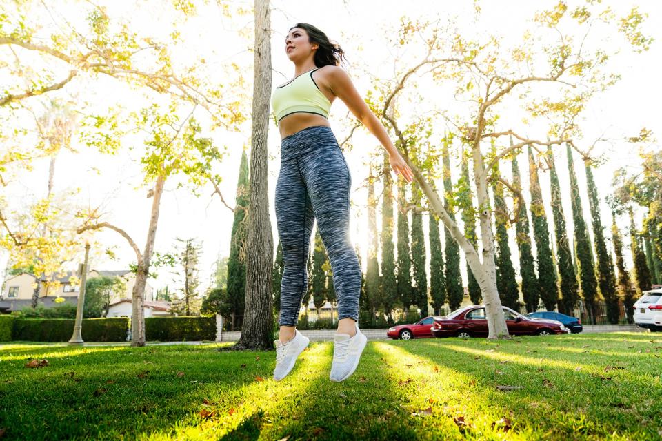 woman jumping while exercising in park