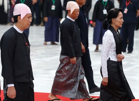 Yangon Chief Minister Phyo Min Thein (L) and Myanmar State Counselor Aung San Suu Kyi attend an event marking the 70th anniversary of Martyrs' Day at the Martyrs' Mausoleum in Yangon, Myanmar July 19, 2017. Picture taken on July 19, 2017. REUTERS/Soe Zeya Tun
