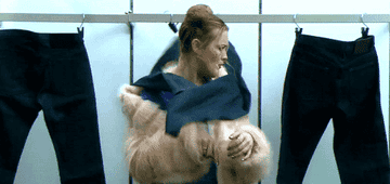 A pair of sentient jeans strangle a young woman in a furry pink coat