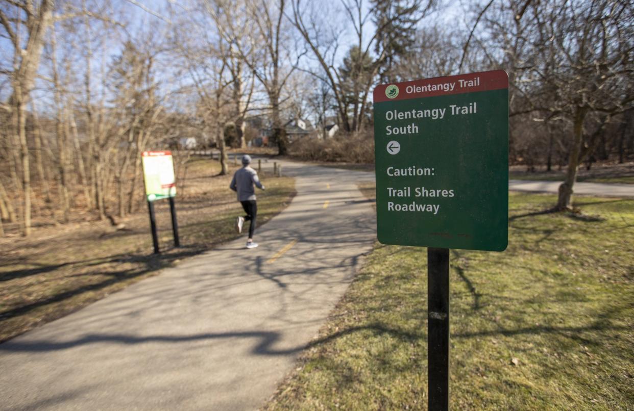 A jogger runs along the Olentangy Trail through Northmoor Park as it exits onto the Olentangy Boulevard in Clintonville.