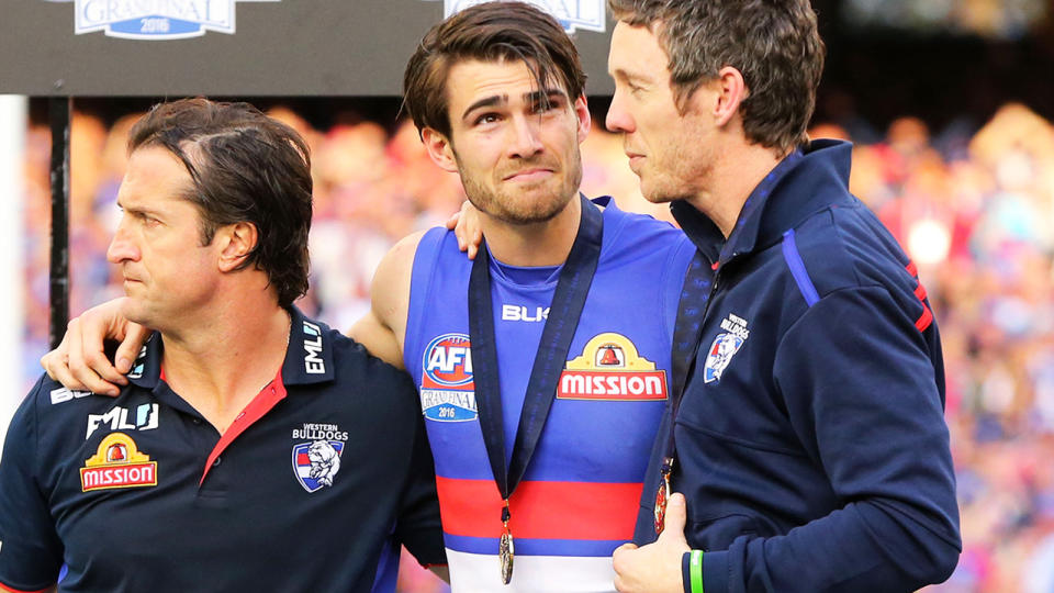 Easton Wood, pictured here with Luke Beveridge and Bob Murphy after the 2016 AFL Grand Final.