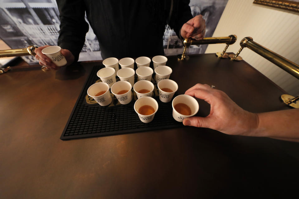 A person takes a sample of rye whiskey during a media preview for the Sazerac house, in New Orleans, Tuesday, Sept. 10, 2019. Visitors to New Orleans who want to learn more about cocktails will soon have a new place to go. No, it's not another bar. The Sazerac House is a six-story building on the city's famed Canal Street owned by the Sazerac Company, a Louisiana-based spirits maker, featuring the signature New Orleans drink called the Sazerac. Tasting is encouraged, and in addition to free samples given to visitors, there will also be special classes and tastings offered daily. (AP Photo/Gerald Herbert)