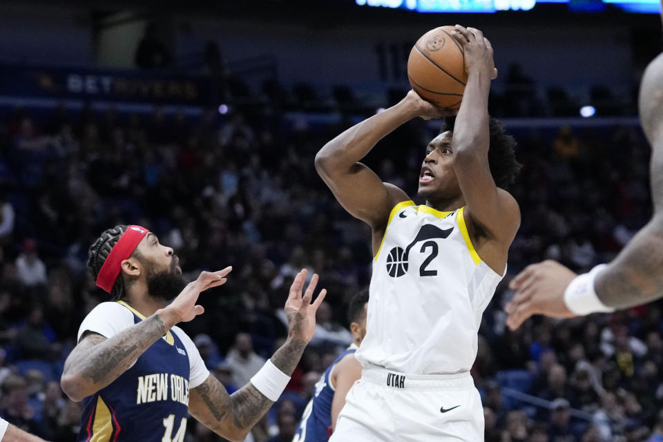 Utah Jazz guard Collin Sexton (2) shoots against New Orleans Pelicans forward Brandon Ingram (14) in the first half of an NBA basketball game in New Orleans, Thursday, Dec. 28, 2023. (AP Photo/Gerald Herbert)