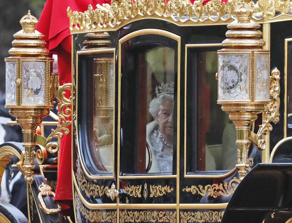 Britain's Queen Elizabeth II travels in a carriage to parliament for the official State Opening of Parliament in London, Monday, Oct. 14, 2019. (AP Photo/Frank Augstein)