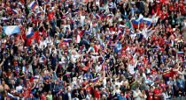 <p>Russia fans celebrate in the stands after the home side go ahead in the opening World Cup game. (Getty) </p>