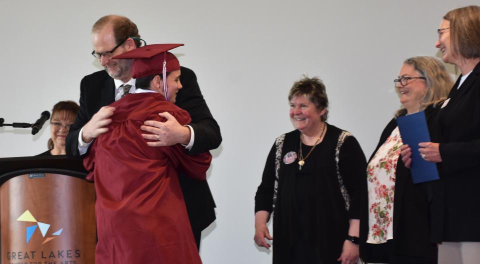 Crooked Tree teacher Don Heinz gives Milo Farnsworth a congratulatory hug after handing him his diploma on June 6, 2023.