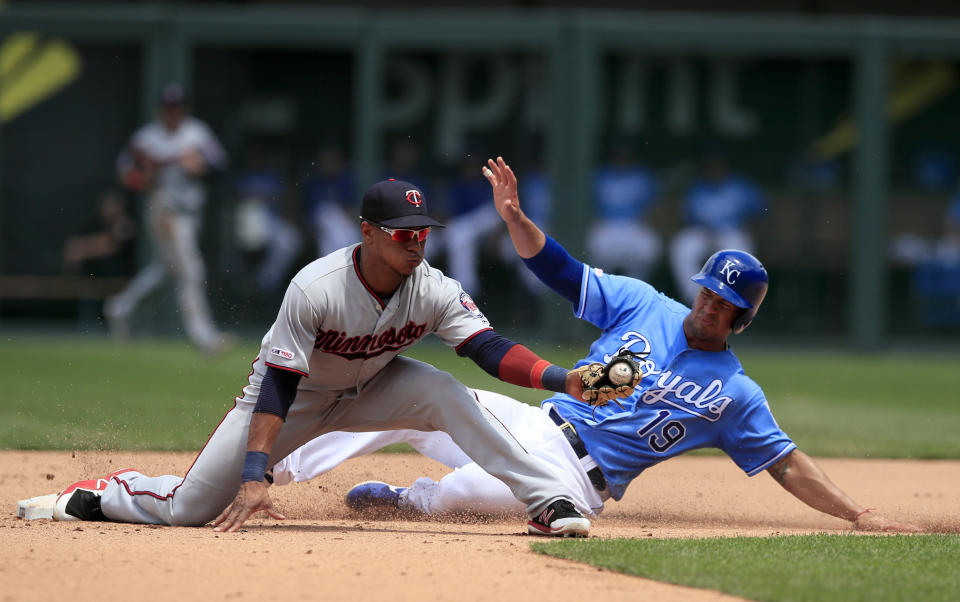 Minnesota Twins shortstop Jorge Polanco, left, forces out Kansas City Royals' Cheslor Cuthbert (19) during the fifth inning of a baseball game at Kauffman Stadium in Kansas City, Mo., Saturday, June 22, 2019. (AP Photo/Orlin Wagner)