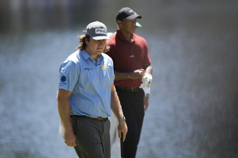 Neal Shipley, left, and Tiger Woods lines up their putts on the 16th hole during final round at the Masters golf tournament at Augusta National Golf Club Sunday, April 14, 2024, in Augusta, Ga. (AP Photo/Charlie Riedel)