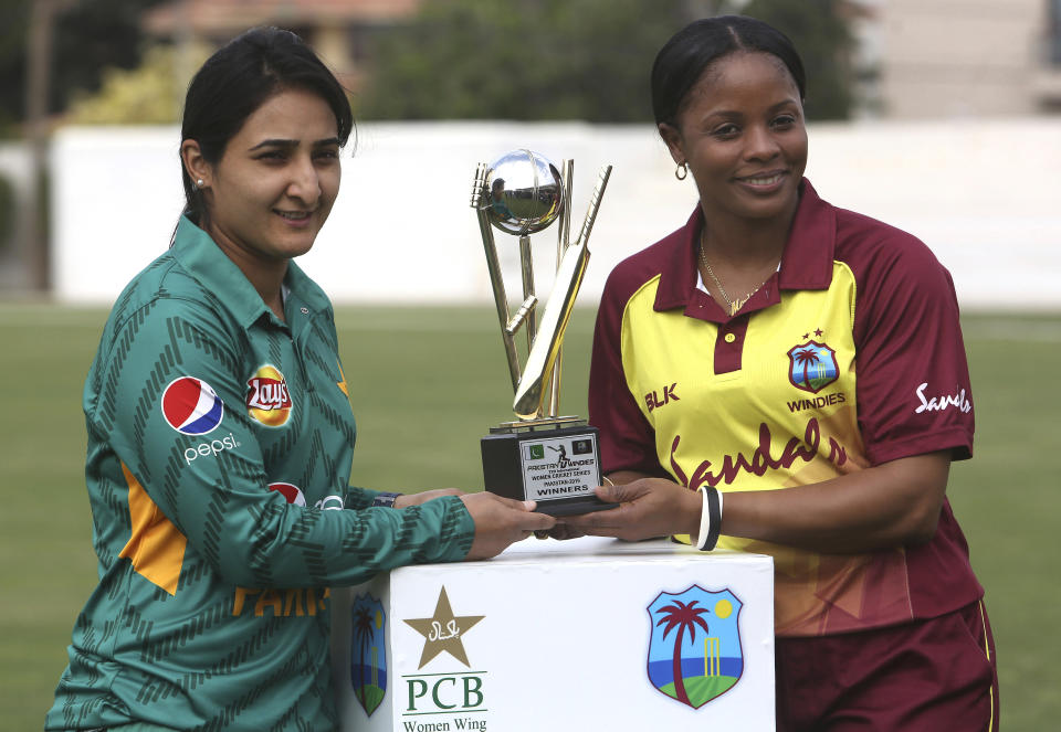 West Indies captain Merissa Aguilleira, right, and Pakistan's captain Bismah Maroof pose with the trophy at Southend Club in Karachi, Pakistan, Wednesday, Jan. 30, 2019. West Indies team arrived in Pakistan after almost 15 years for international cricket as it plays three Twenty20 internationals at Karachi. (AP Photo/Fareed Khan)