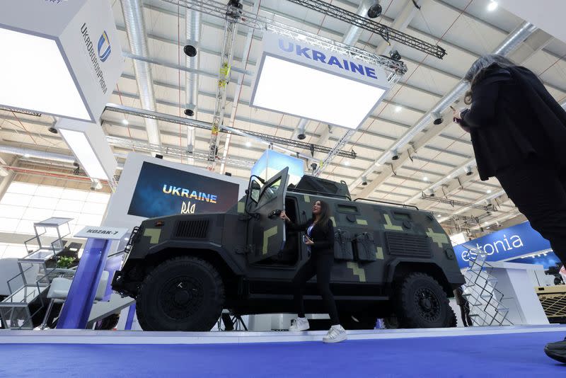 A visitor checks an Armored Personnels Carriers at Ukrainian Military stand displaying the latest defense system at World Defense Show in Riyadh, Saudi Arabia