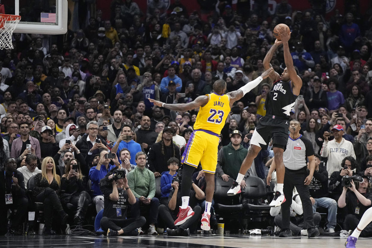 Los Angeles Clippers forward Kawhi Leonardl, right, shoots and misses as Los Angeles Lakers forward LeBron James defends with seconds left in the second half of an NBA basketball game Wednesday, Feb. 28, 2024, in Los Angeles. (AP Photo/Mark J. Terrill)