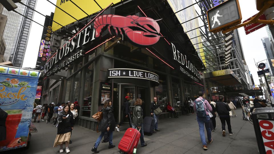 People walk past a Red Lobster seafood restaurant in Times Square, New York, on May 15, 2024. - Anthony Behar/SIPPL Sipa USA/AP