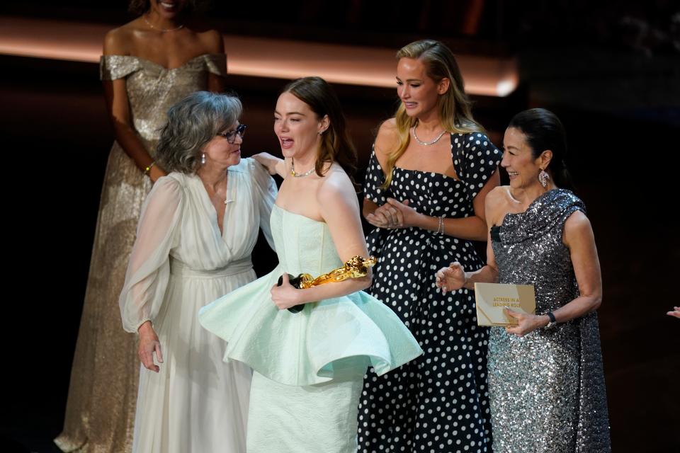 Emma Stone accepts the award for best actress in a leading role for her role in "Poor Things" on stage qwith Sally Field, Jennifer Lawrence and Michelle Yeoh during the 96th Oscars at the Dolby Theatre at Ovation Hollywood in Los Angeles on March 10, 2024.