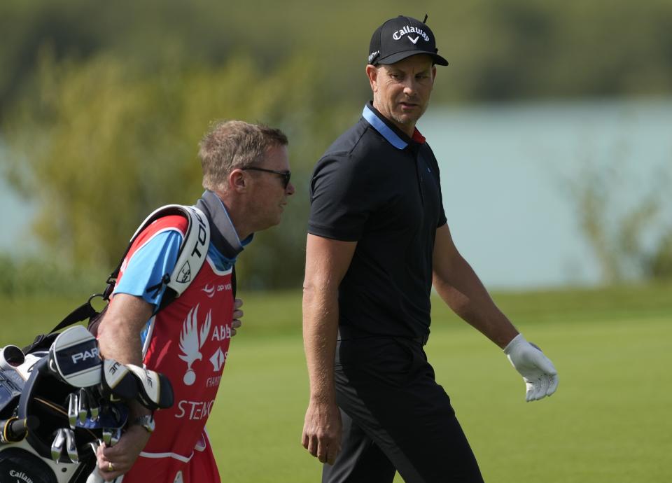 Henrik Stenson of Sweden talks to his caddie on the 18th hole during the first round of Abu Dhabi HSBC Golf Championship, in Abu Dhabi, United Arab Emirates, Thursday, Jan. 19, 2023. (AP Photo/Kamran Jebreili)