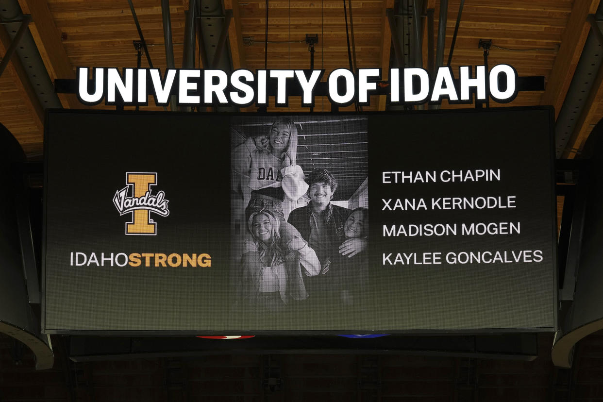 FILE - A photo and the names of four University of Idaho students who were killed over the weekend at a residence near campus are displayed during a moment of silence, Nov. 16, 2022, before an NCAA college basketball game in Moscow, Idaho. The Moscow Police Department has yet to name a person of interest in the stabbing deaths of the students . (AP Photo/Ted S. Warren, File)