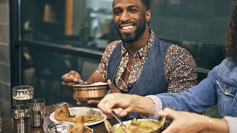 Man enjoying platters indian food