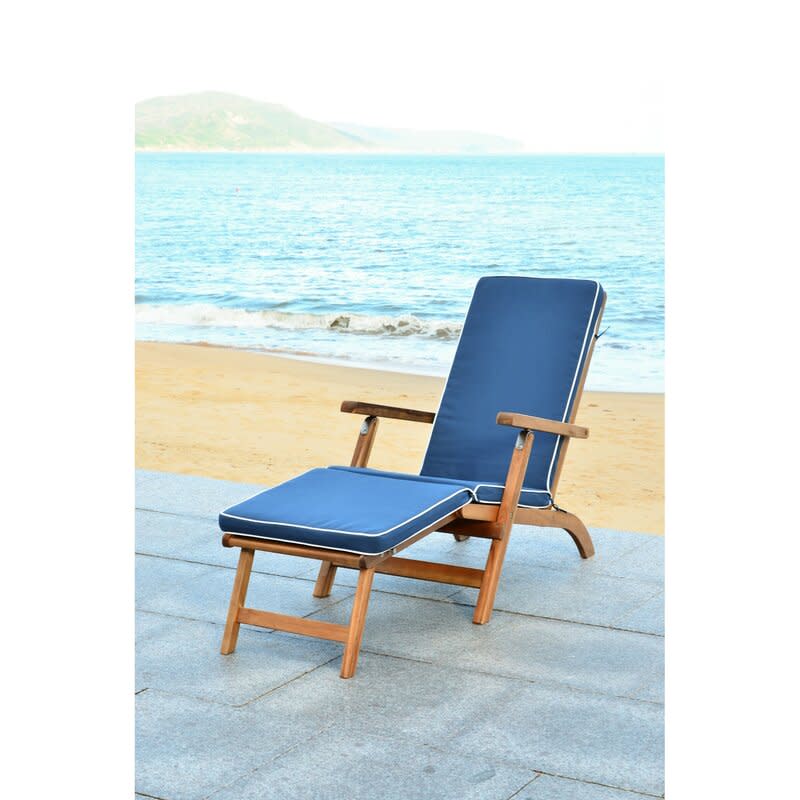 Weather-resistant acacia wood keeps this comfy lounger going strong. (Photo: Wayfair)