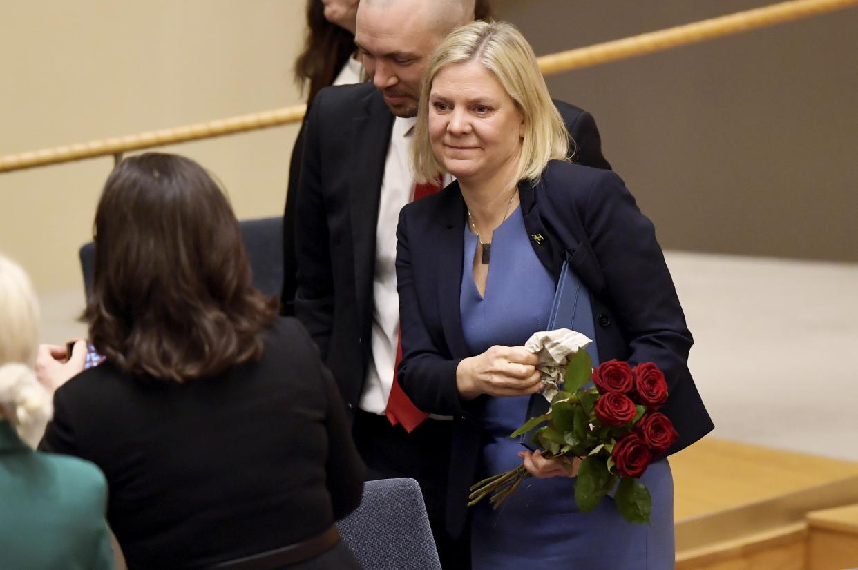 Sweden's Finance Minister and Scocial Democratic Party leader Magdalena Andersson holds flowers after a vote appointing her as Sweden's new prime minister, in the Swedish parliament Riksdagen, in Stockhom, Wednesday, Nov. 24, 2021.  Sweden’s parliament has approved Magdalena Andersson as the country’s first female prime minister. Lawmakers on Wednesday tapped the finance minister who recently became the new leader of the Social Democratic party. Andersson was tapped to replace Stefan Lofven as party leader and prime minister, roles he relinquished earlier this year. (Erik Simander/TT News Agency via AP)