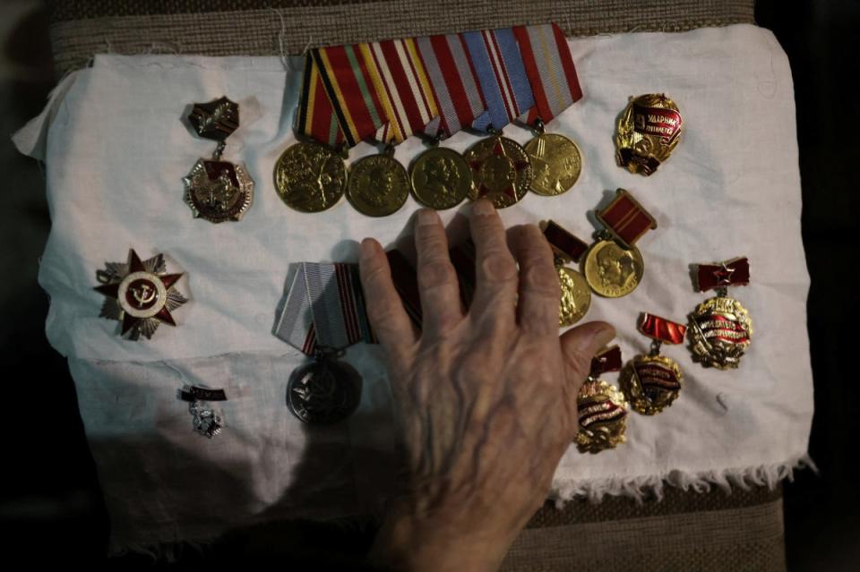 Maria arranges the medals awarded to her late husband, Vasilii Emelianovich (Reuters)