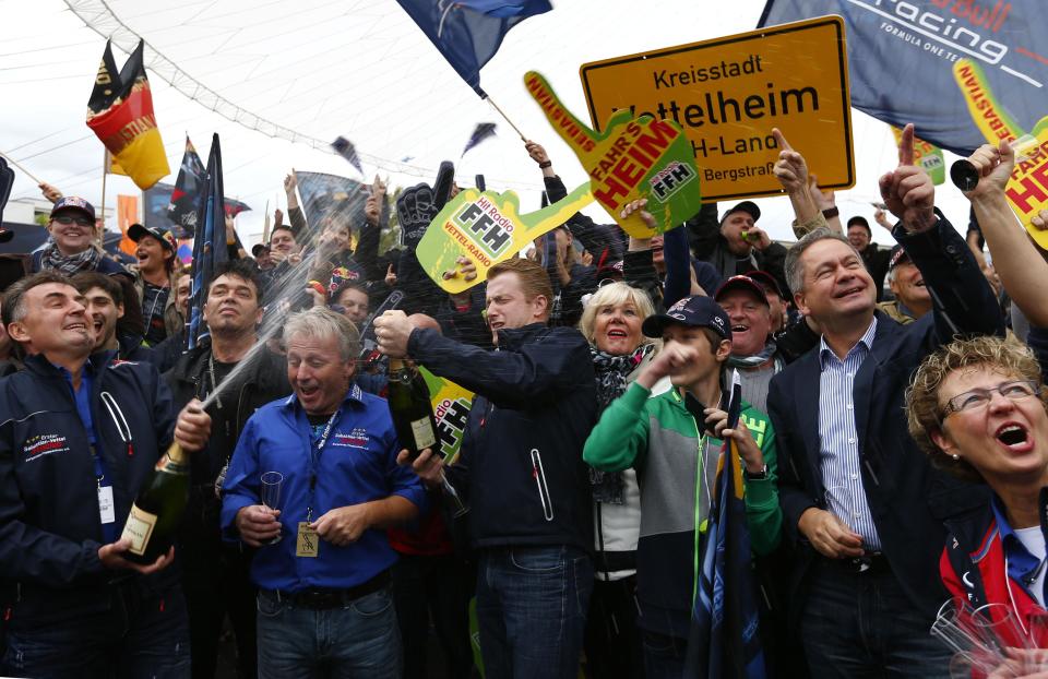 Supporters of Germany's Red Bull Formula One driver Vettel celebrate during public viewing session of the Formula One Grand Prix of India in Heppenheim