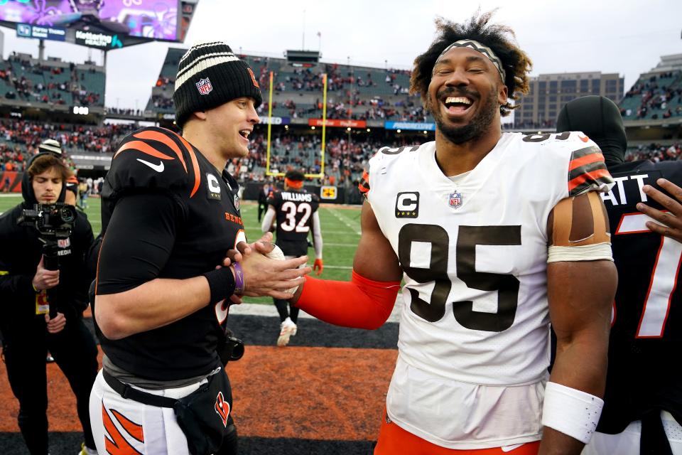 Cincinnati Bengals quarterback Joe Burrow (9) and Cleveland Browns defensive end Myles Garrett (95) share a laugh at the conclusion of a Week 14 NFL game, Sunday, Dec. 11, 2022, at Paycor Stadium in Cincinnati. The Battle of Ohio will both start and finish the regular season schedule.