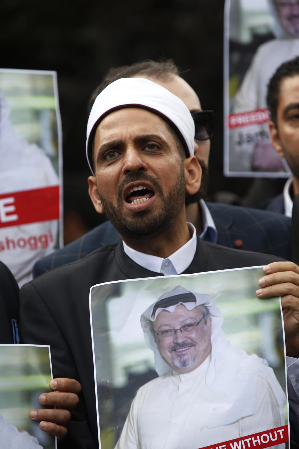 A members of the Turkish-Arab journalist association holds a poster with a photo of missing Saudi writer Jamal Khashoggi, as they hold a protest near the Saudi Arabia consulate in Istanbul, Monday, Oct. 8, 2018. Khashoggi, 59, went missing on Oct 2 while on a visit to the consulate in Istanbul for paperwork to marry his Turkish fiancée. The consulate insists the writer left its premises, contradicting Turkish officials. He had been living since last year in the U.S. in a self-imposed exile, in part due to the rise of Prince Mohammed, the son of King Salman. (AP Photo/Lefteris Pitarakis)