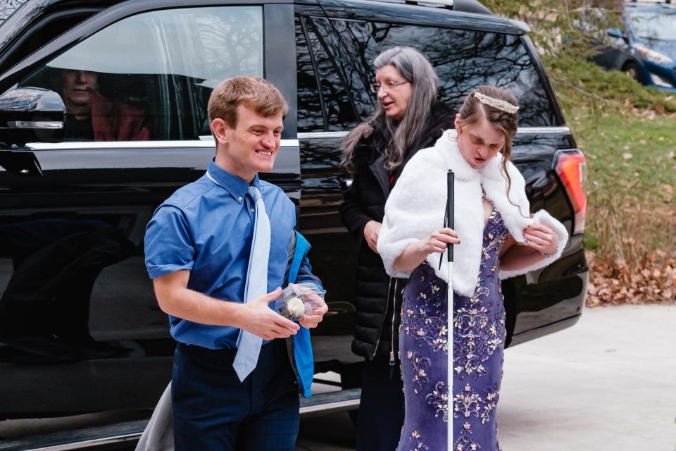 Alec Worth and Kaylee Arthurs walk toward the garage of the Worth family home in New Philadelphia to get ready for the Night to Shine.