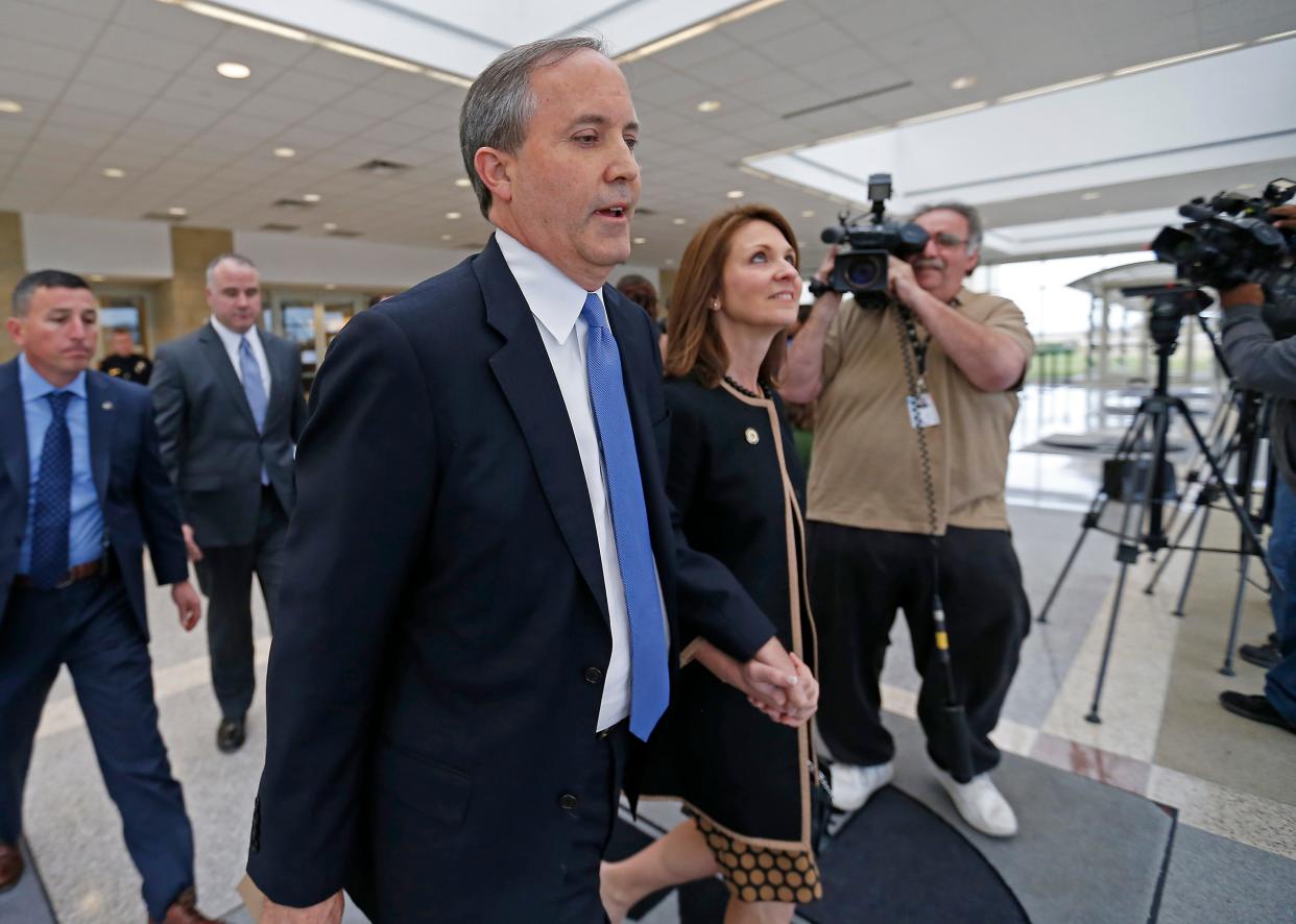 Texas Attorney General Ken Paxton, left, and his wife Angela leave the Collin County courthouse after his pre-trial motion hearing on Tuesday, Dec. 1, 2015, in McKinney, Texas.