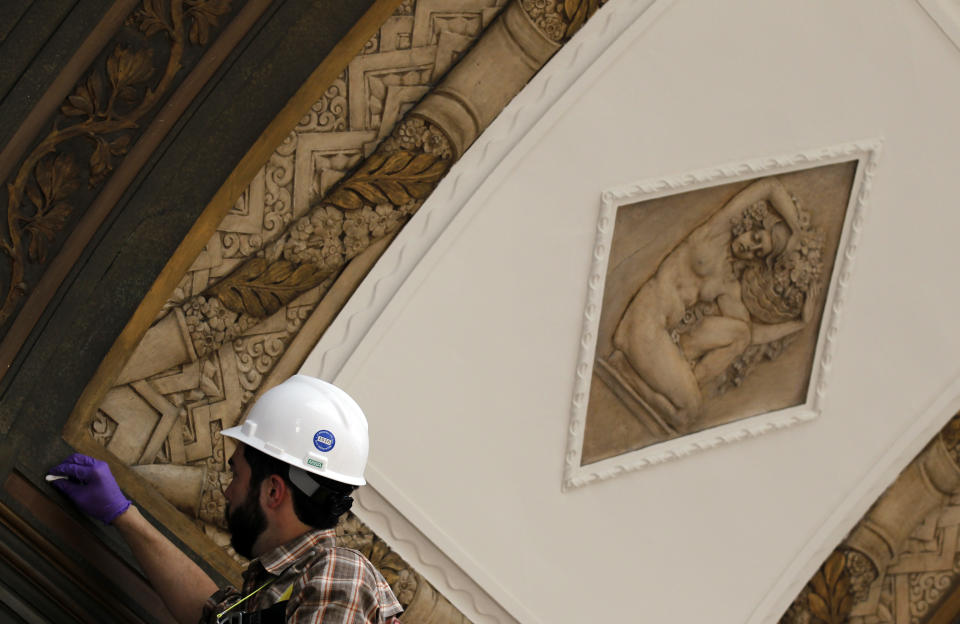 Tobias Canfield, with Materials Conservation Collaborative, LLC, puts the final touches on the plaster relief on the ceiling of the main gallery of the Rodin Museum on Wednesday, May 16, 2012, in Philadelphia. After a three-year renovation, the museum is scheduled to reopen to the public on July 13. (AP Photo/Alex Brandon)