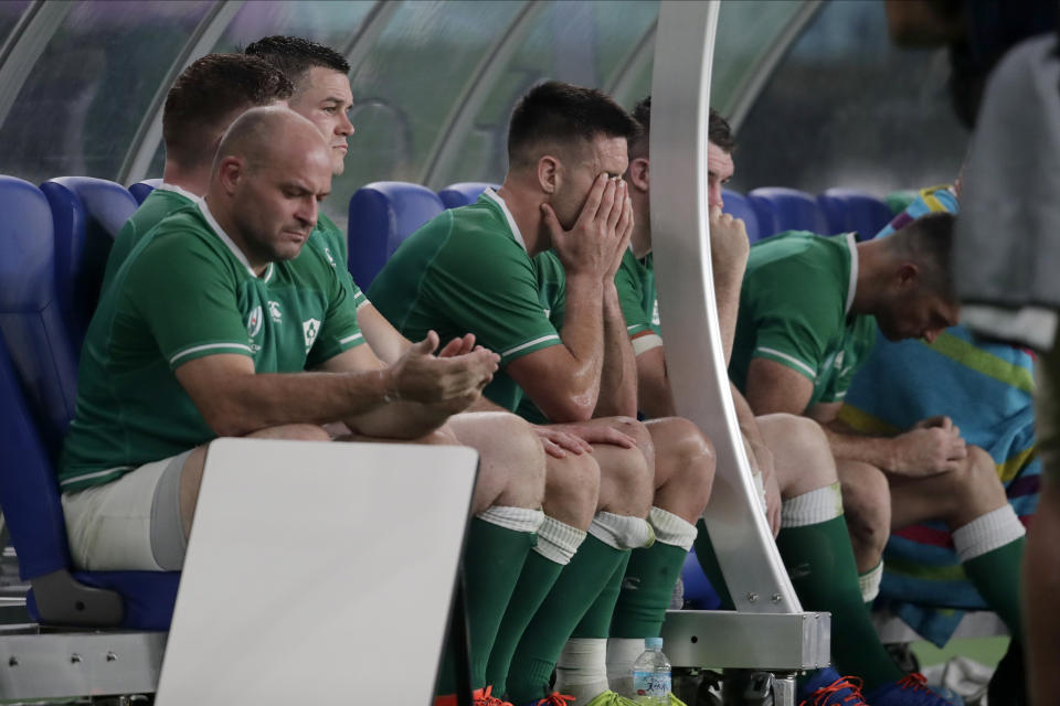 Players react in the Ireland bench during the Rugby World Cup quarterfinal match at Tokyo Stadium between New Zealand and Ireland in Tokyo, Japan, Saturday, Oct. 19, 2019. (AP Photo/Jae C. Hong)