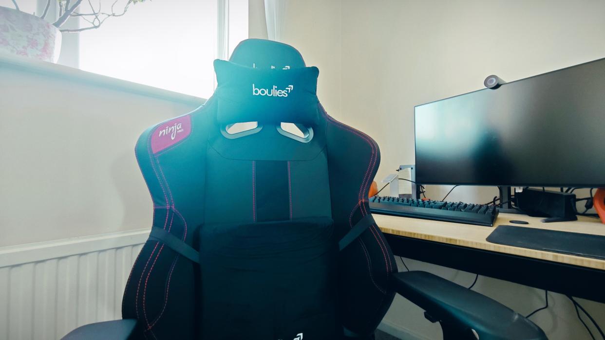  A black Boulies Ninja Pro chair in a small office. 