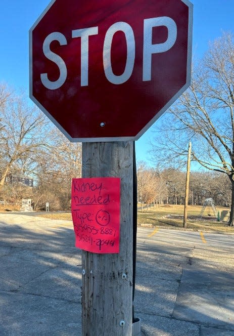 A sign soliciting a kidney is attached to a stop sign at 34th Street and Adams Avenue near Beaverdale Park in Des Moines on Tuesday, Feb. 20, 2024.